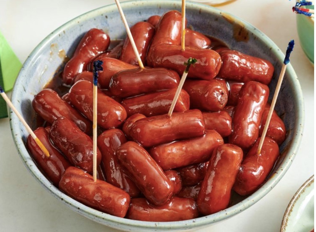 Bowl of glazed cocktail smoked sausages with toothpicks