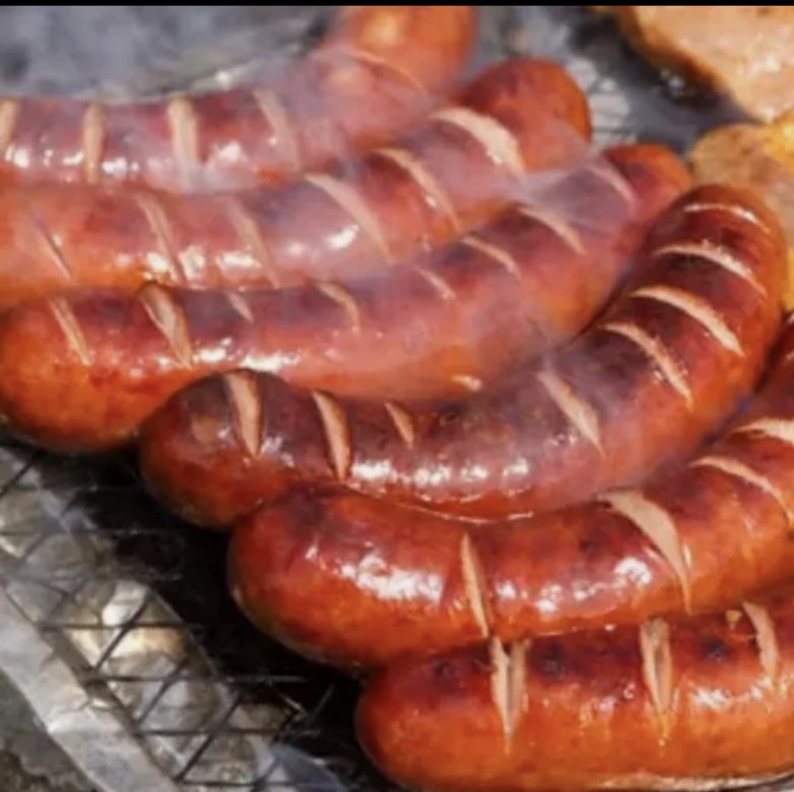Smoked sausage links on a grill