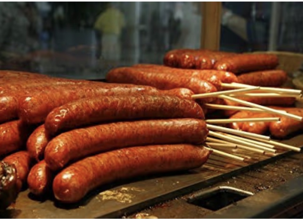 Smoked sausages on sticks ready for concession serving